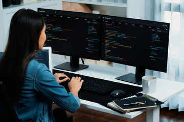 Young Asian in IT developer creating with typing online information on pc with coding program data...