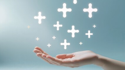 A hand holding glowing plus signs on a light blue background, symbolizing healthcare, medical healing energy, wellness, and positive symbols