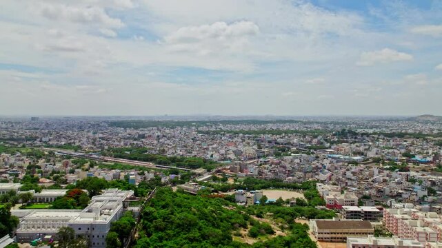 Taj Falaknuma Palace with hyderabad city view, sky and clouds at Engine Bowli, Falaknuma, Hyderabad, Telangana, india. day time, push in, drone shot. 4k