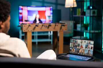 Teleworker and coworkers in call crosschecking analytics statistical data sets in dimly lit...