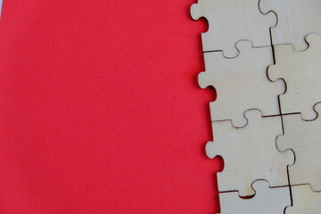 wooden puzzle on plain color paper with text space concept. 