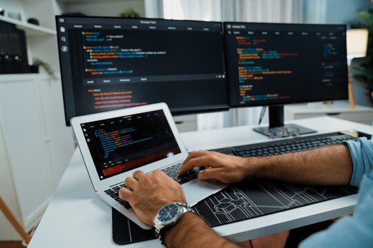 Cropped typing hands photo in IT developer working software development coding on laptop with creating application program update version website on two computer code screen at modern office. Surmise.