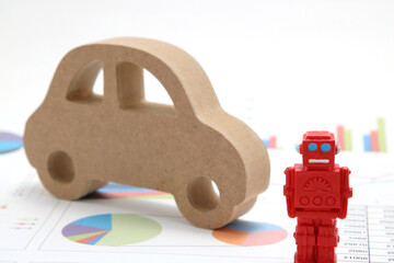 ロボットと車のミニチュアとグラフのビジネスコンセプト
