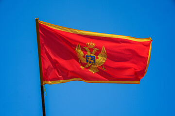 Montenegro flag waving against a blue sky