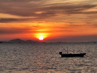 Naklejka premium fishing boat at sunset