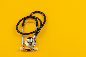 Stethoscope on yellow background symbolizing healthcare awareness and support