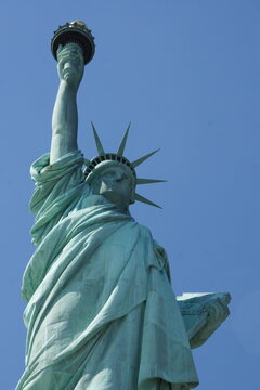 Close-up reveals New York's Statue of Liberty's weathered green face crowned with hope. A symbol of enduring freedom, welcoming all. Or a reminder of time's passage and aging icons.