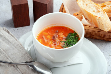 Soup with beans, vegetables and beef - served with parsley and toasted bread
