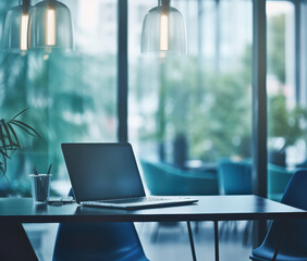modern workspace featuring laptop on table, surrounded by greenery and soft lighting, creating calm and productive atmosphere
