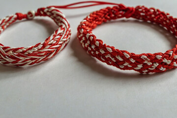 Martenitsa. Red and white bracelet specific to Balkan and Bulgarian culture. Balkan tradition Martenitsa. Bracelet symbolizing the arrival of spring.