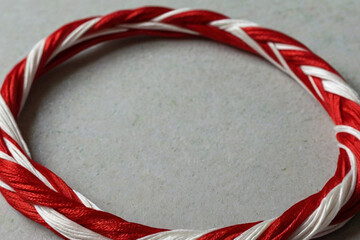 Martenitsa. Red and white bracelet specific to Balkan and Bulgarian culture. Balkan tradition Martenitsa. Bracelet symbolizing the arrival of spring.