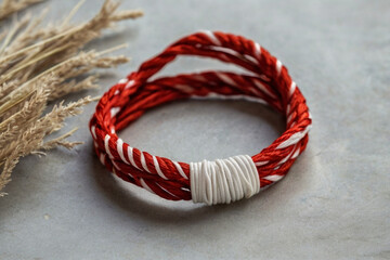 Martenitsa. Red and white bracelet specific to Balkan and Bulgarian culture. Balkan tradition Martenitsa. Bracelet symbolizing the arrival of spring.