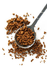 Spoon with aromatic instant coffee isolated on white, top view