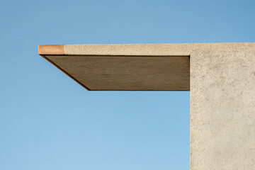 Fototapeta premium Modern architectural design with a cantilevered roof against a clear blue sky