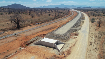 Modern Highway Under Construction Beside an Old Railway