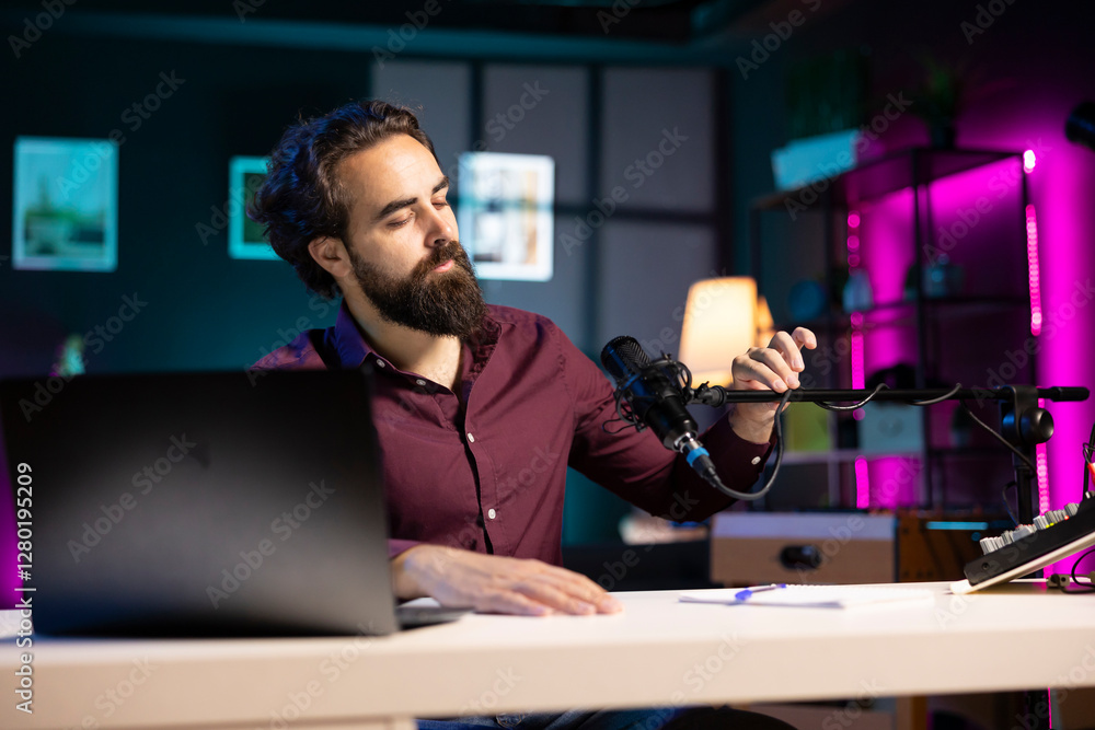 Poster content creator adjusting professional microphone in studio before starting recording video for onli