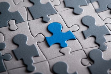 Unique blue puzzle piece in gray puzzle, teamwork concept