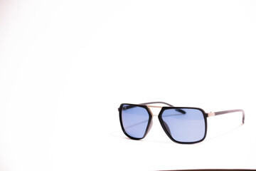 Sunglasses with black frame and blue glasses. Sun glasses. Modern blue sunglasses on white...