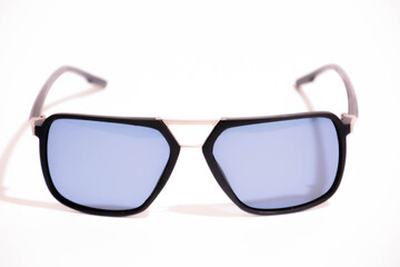 Sunglasses with black frame and blue glasses. Sun glasses. Modern blue sunglasses on white...