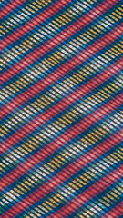 Colorful patterned fabric with diagonal stripes and geometric shapes displayed in vibrant hues beautifully textured 