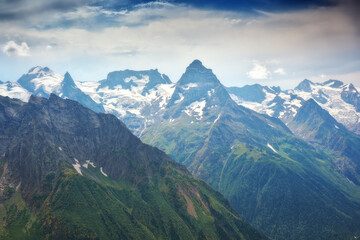 Nature landscape of Dombay Ulgen mountain glacier at cloudy day