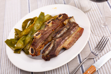 Churrasco de ternera, delicious grilled veal ribs with a side of beans