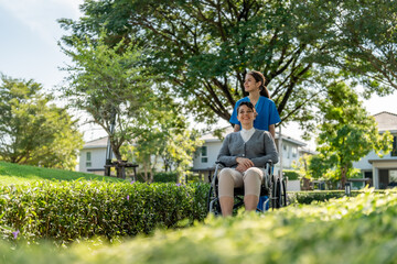 caregiver pushing wheelchair in park, enjoying sunny day. scene conveys warmth and compassion,...