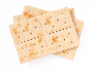 Close-up of crispy saltine crackers isolated on a white background. Simple and classic snack,...