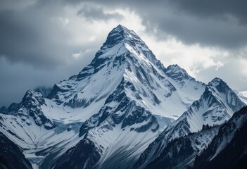 Obraz premium Majestic Snow-Capped Mountain Peak Under Dramatic Sky – Breathtaking Landscape Photography