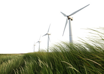 Wind turbines spin gently over tall grass fields in an open landscape on a clear day with bright skies