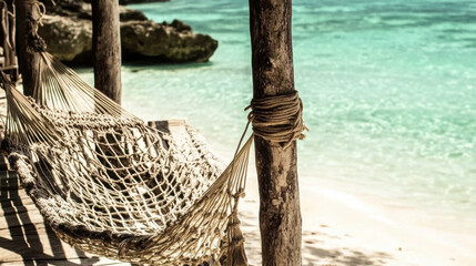 Obraz premium serene beach scene featuring hand woven hammock strung between wooden posts, inviting relaxation by turquoise waters. tranquil atmosphere enhances beauty of nature
