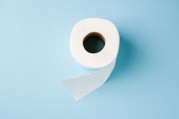 Top view of toilet paper roll on blue background