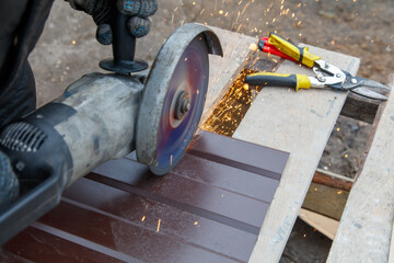 A man is using a power tool to cut a piece of wood