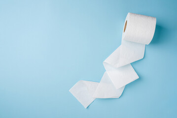 Top view of toilet paper roll on blue background