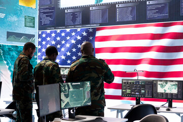 American military intelligence officers in a command center monitoring surveillance information in...