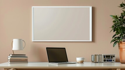 A white rectangular frame above a desk in a home office, with a cup, a laptop, and a stack of books   HD 8K mockup wallpaper Photographic Image