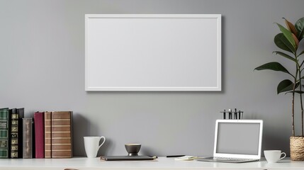 A white rectangular frame above a desk in a home office, with a laptop, a coffee cup, and a few books next to it.   HD 8K mockup wallpaper Photographic Image