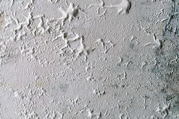 The blistered surface of cement wall. Swollen color wall from the moisture. Cracked wall, Paint white peeling off and old outside wall. Blistering occurs due to humidity, Wet wall surfaces and mold.