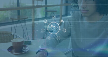 Image of network of connections with icons over data processing and biracial man using laptop