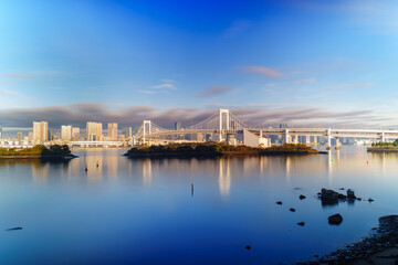Obraz premium Tokyo skyline with Rainbow Bridge and Tokyo Tower at sunrise