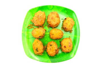 tempting potato cakes on a green plate patterned with banana leaves