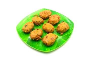 tempting potato cakes on a green plate patterned with banana leaves