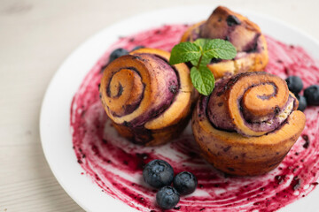 Delicious cinnamon roll and blueberry dessert.