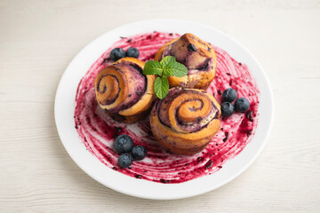 Delicious cinnamon roll and blueberry dessert.