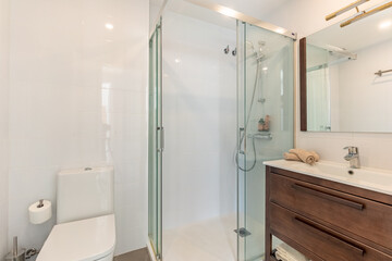 a close up image of a standing shower and sink in mediterranean apartment 