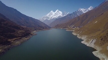 Mountain lake aerial view, village, snow peaks