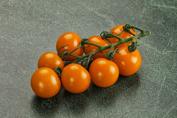 Yellow sweet tomato on the branch