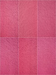 Fototapeta premium A close up of a pink carpet with a pink background. The carpet is made up of different shades of pink