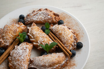 Sweet fried empanadas filled with fruit and blueberries.