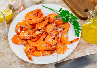 Dish of Mediterranean cuisine - baked in oven langoustine served with lemon